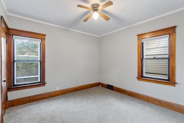 empty room featuring carpet flooring, ceiling fan, and ornamental molding