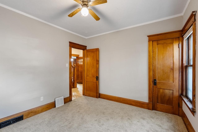 carpeted bedroom featuring ceiling fan and crown molding