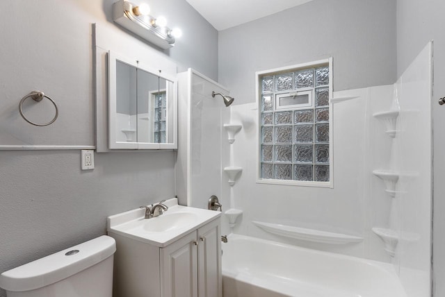 full bathroom with a wealth of natural light, toilet, vanity, and tub / shower combination