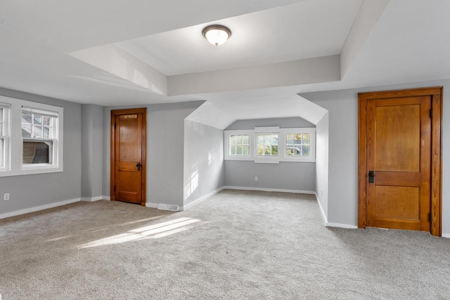 additional living space with light colored carpet and a healthy amount of sunlight