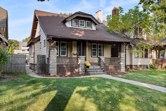 craftsman house featuring a front lawn and a porch