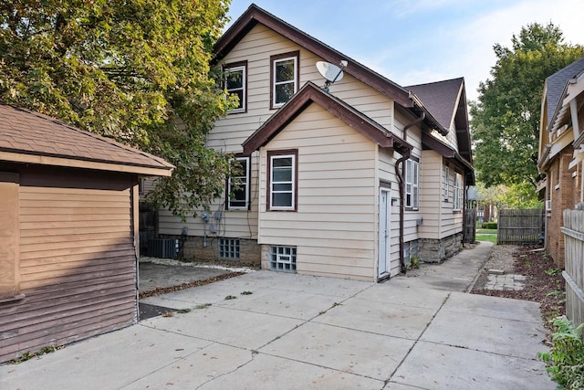 rear view of house featuring central AC unit and a patio area