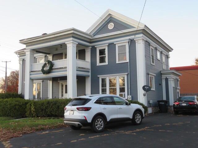 neoclassical home with a balcony