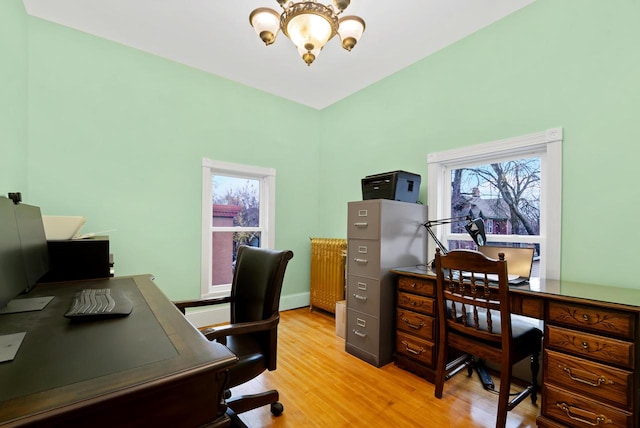 office area with an inviting chandelier, light hardwood / wood-style flooring, and a healthy amount of sunlight