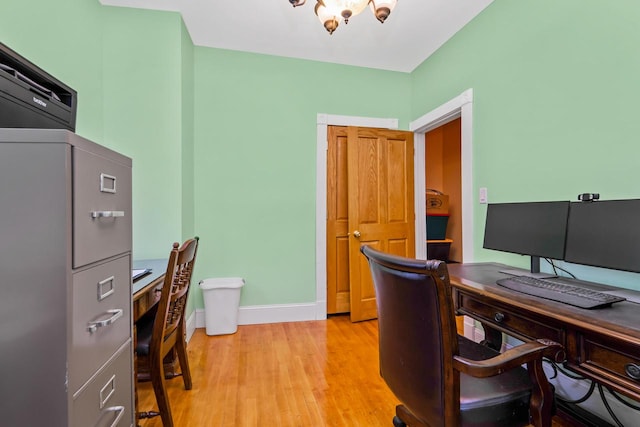 office area featuring a notable chandelier and light hardwood / wood-style flooring