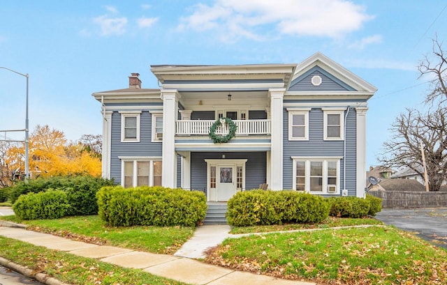 neoclassical home with a balcony