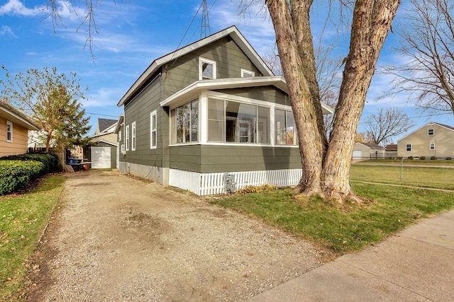 view of front of property with a garage and a front lawn