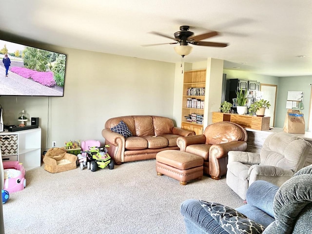 carpeted living room with ceiling fan