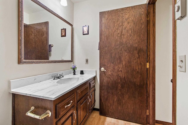 bathroom featuring wood-type flooring and vanity