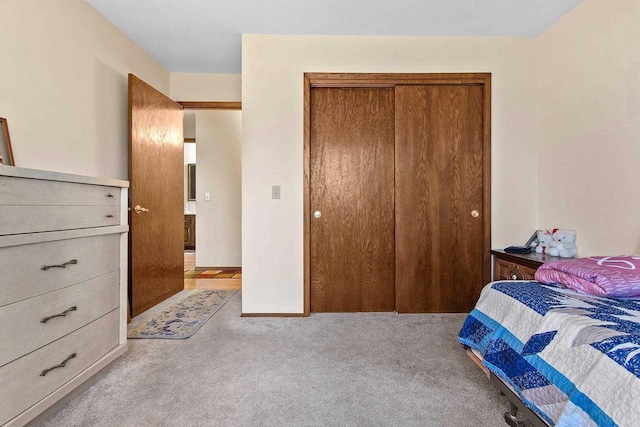 bedroom with light colored carpet and a closet