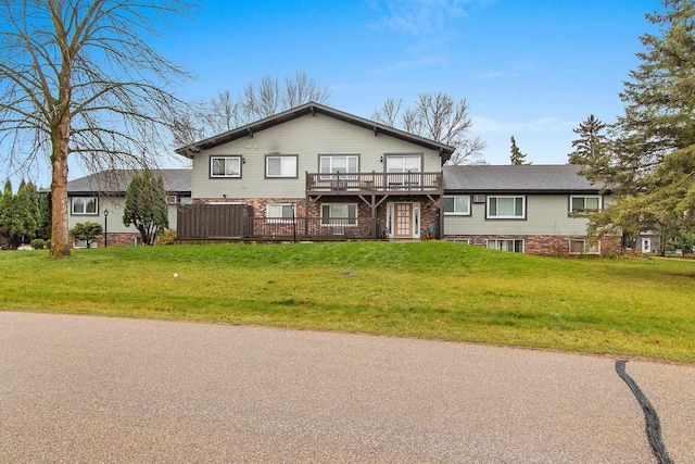 view of front of house with a front lawn and a wooden deck