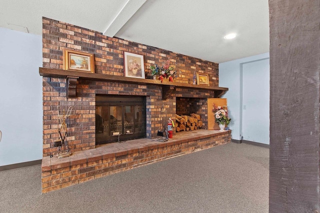 unfurnished living room with beam ceiling, carpet floors, a textured ceiling, and a brick fireplace