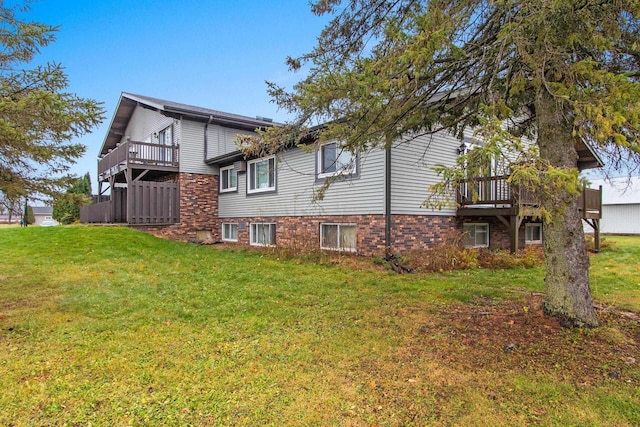 back of house with a yard and a wooden deck