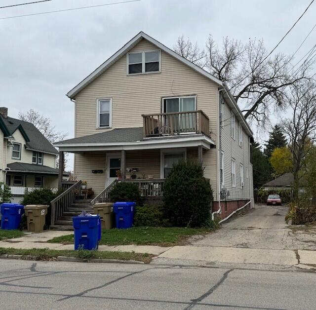 view of front of home with a porch and a balcony