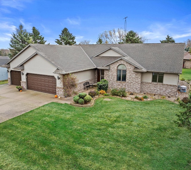 view of front of home featuring a front yard and a garage