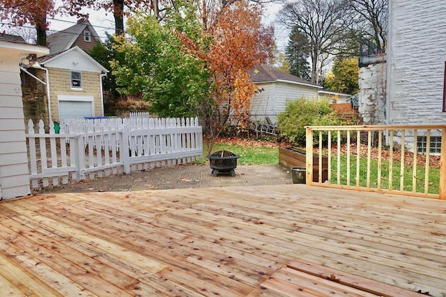 wooden deck featuring an outdoor fire pit