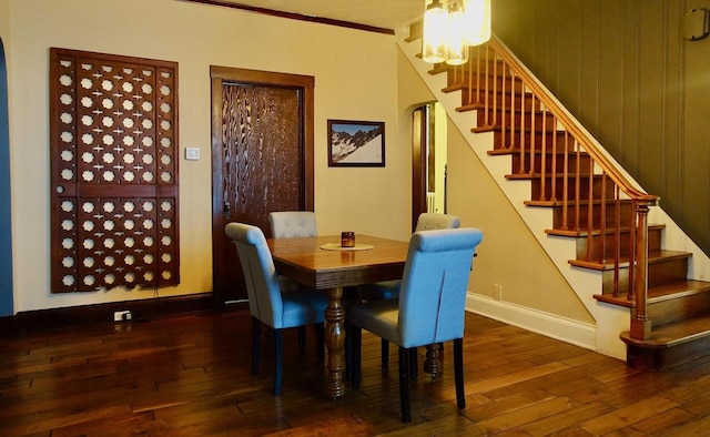 dining area featuring dark hardwood / wood-style flooring and ornamental molding