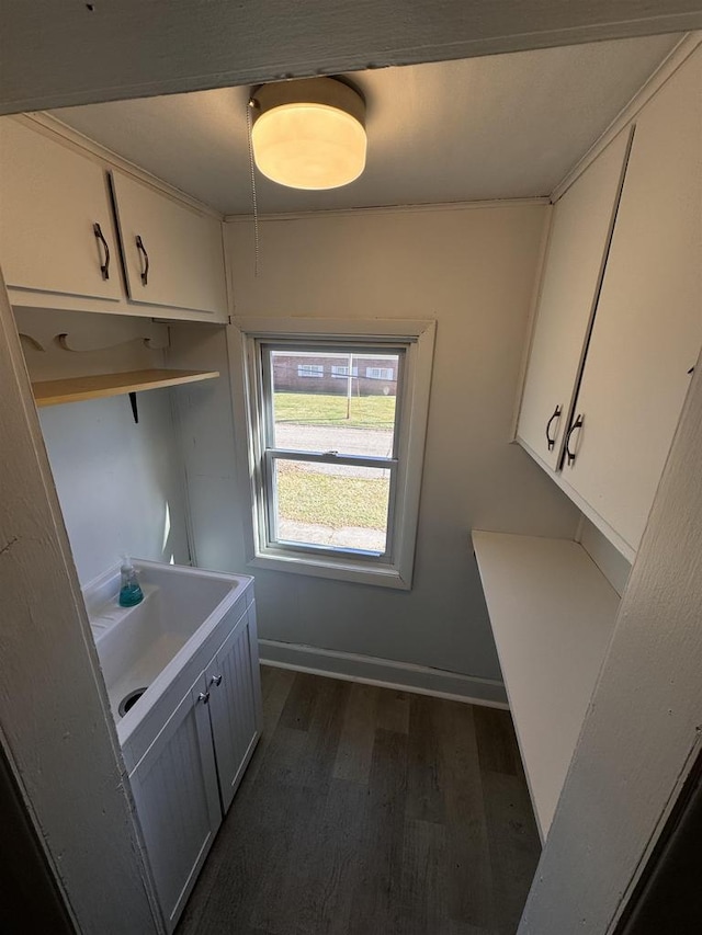 interior space featuring white cabinets and dark wood-type flooring