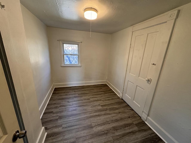 unfurnished room featuring dark wood-type flooring