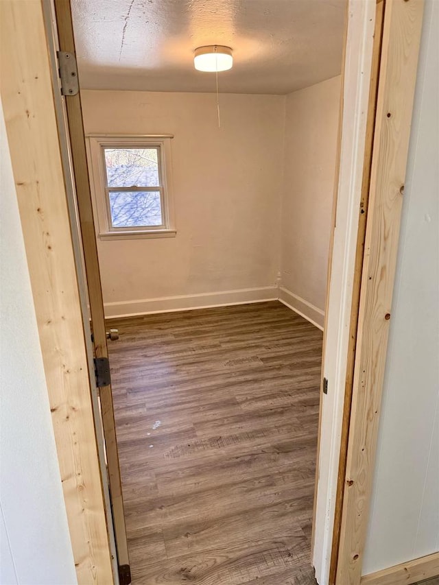 unfurnished room with dark hardwood / wood-style flooring