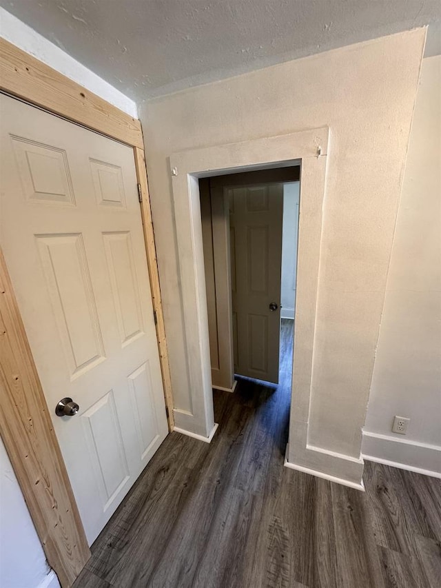 hallway with dark wood-type flooring