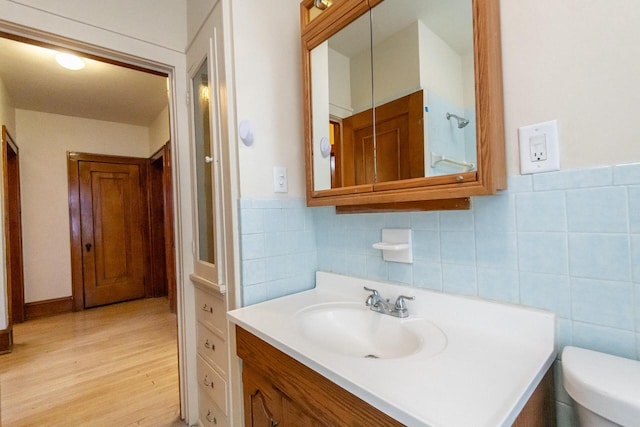 bathroom featuring wood-type flooring, vanity, and toilet