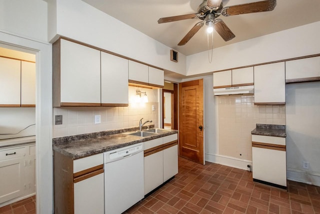 kitchen featuring decorative backsplash, white dishwasher, ceiling fan, sink, and white cabinets