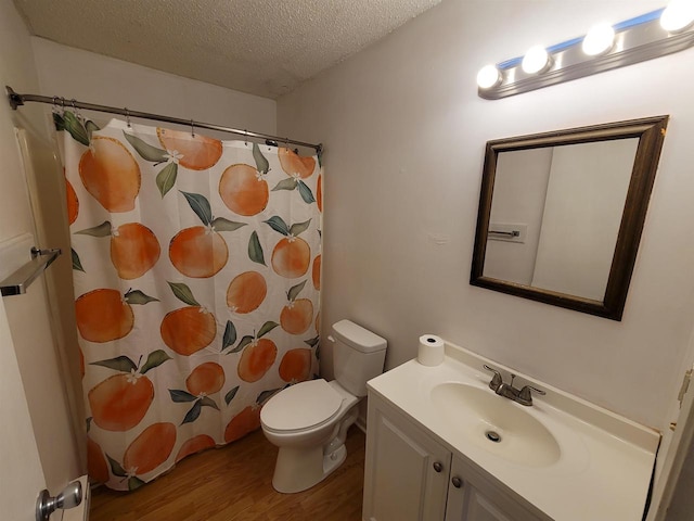 bathroom with vanity, a textured ceiling, hardwood / wood-style flooring, and toilet