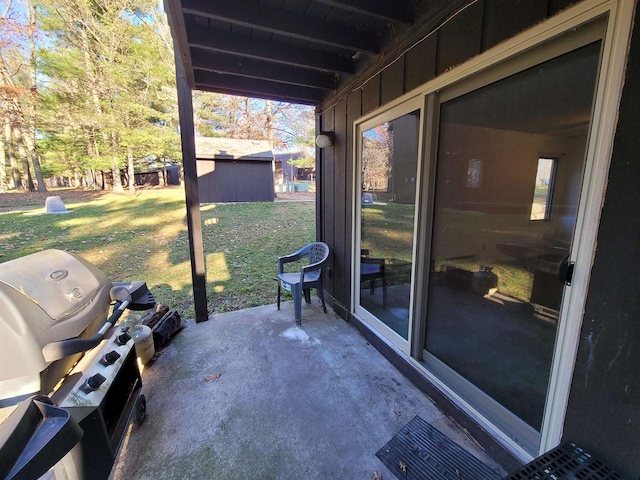 view of patio / terrace with grilling area and a storage shed