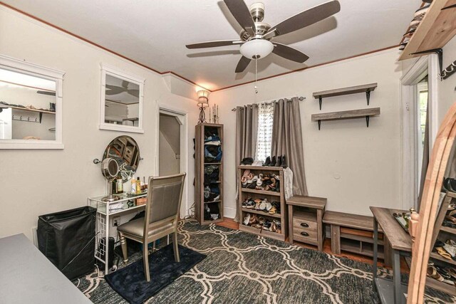 office area featuring crown molding, dark wood-type flooring, and ceiling fan