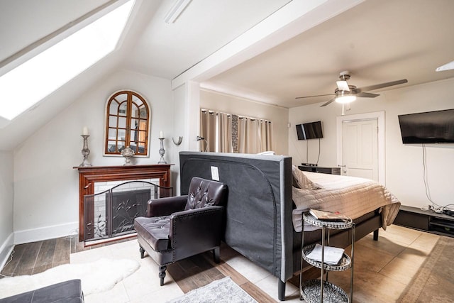 330 E Locust St, Milwaukee, WI 53212 - bedroom with a skylight, a fireplace, lofted ceiling, a ceiling fan, and baseboards