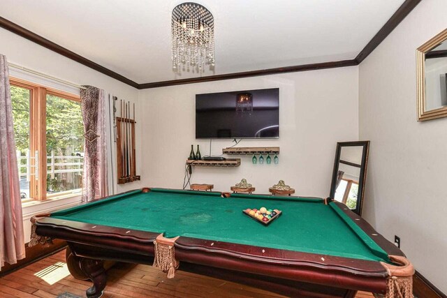 rec room with wood-type flooring and ornamental molding