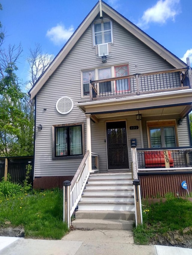 view of front of property with a balcony and a porch