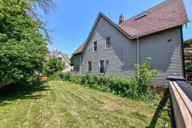 view of side of home with a lawn