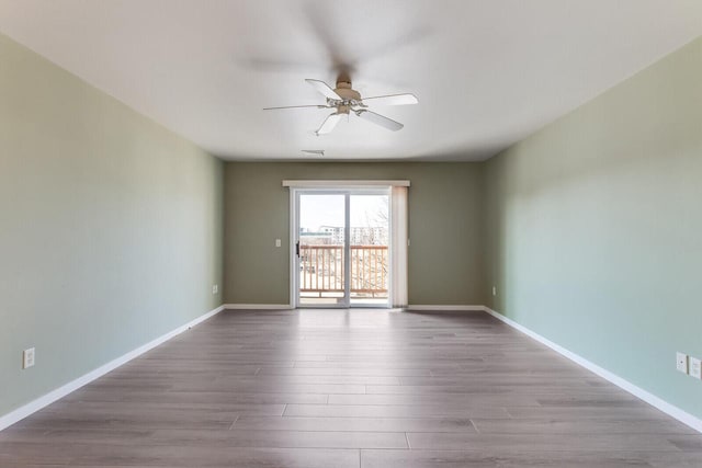 spare room featuring ceiling fan and light hardwood / wood-style flooring