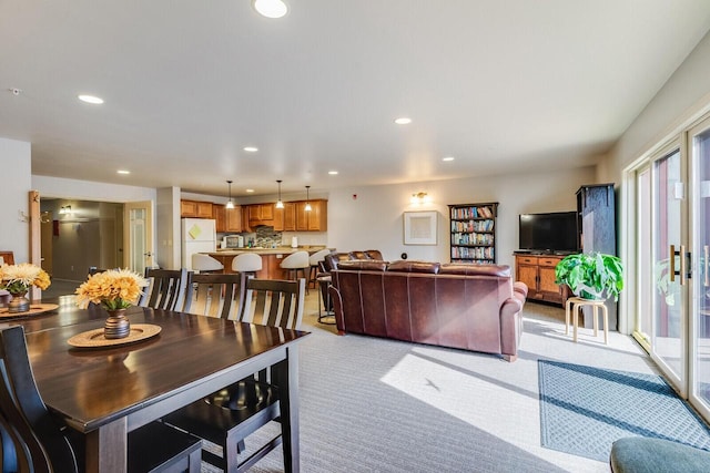 dining space featuring light colored carpet and a wealth of natural light