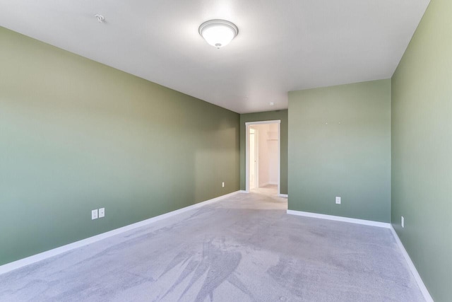 unfurnished room featuring light colored carpet