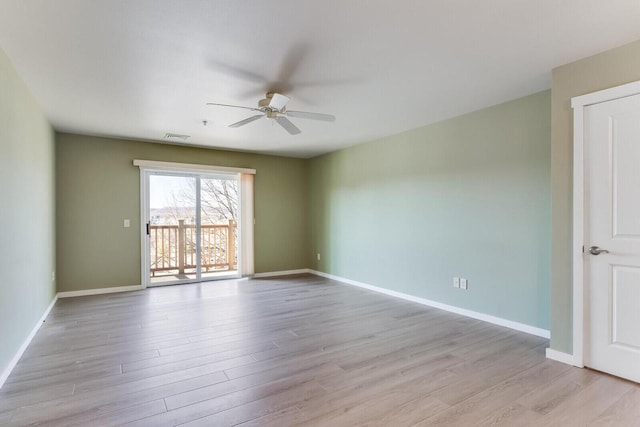 empty room with ceiling fan and light hardwood / wood-style flooring