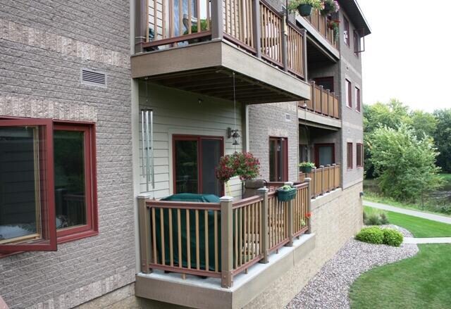 exterior space featuring a lawn and a balcony