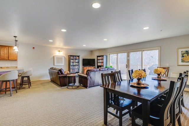 dining space featuring light colored carpet