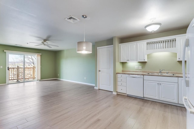 kitchen with pendant lighting, white appliances, light hardwood / wood-style flooring, and white cabinetry