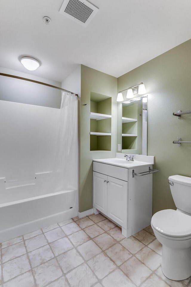 full bathroom featuring tile patterned floors, vanity, toilet, and shower / bath combo with shower curtain