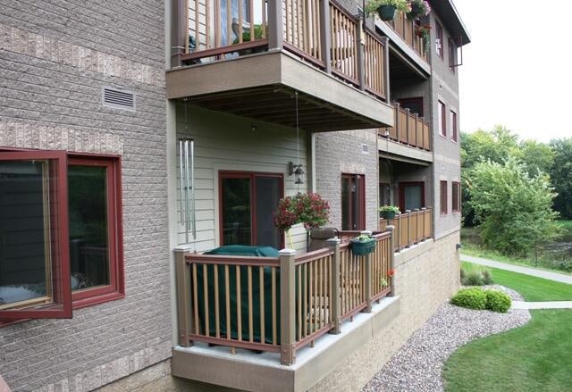 exterior space with a lawn and a balcony