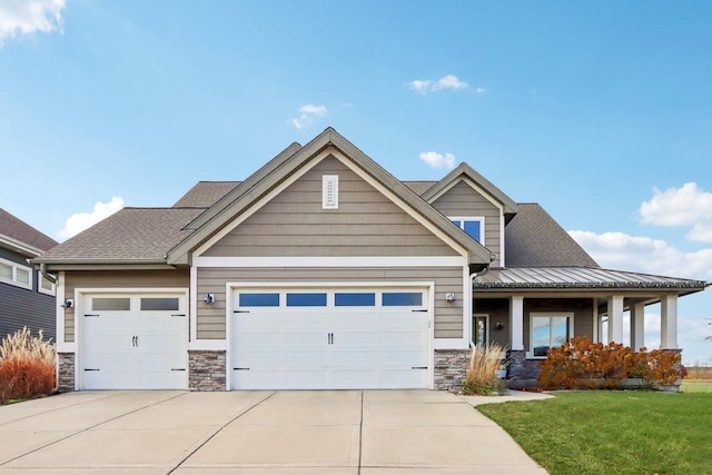 craftsman-style house with a garage and a front lawn