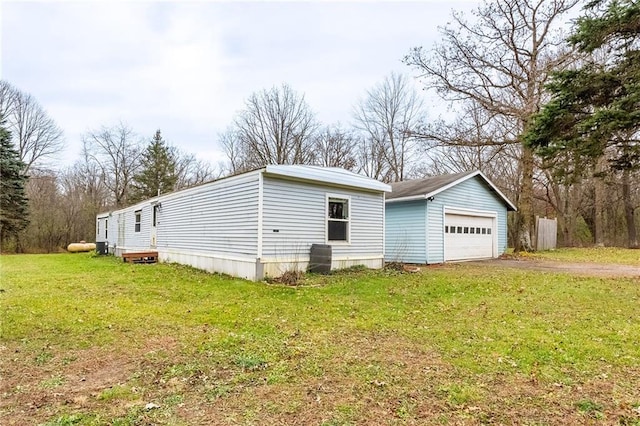 view of side of home with a yard and a garage