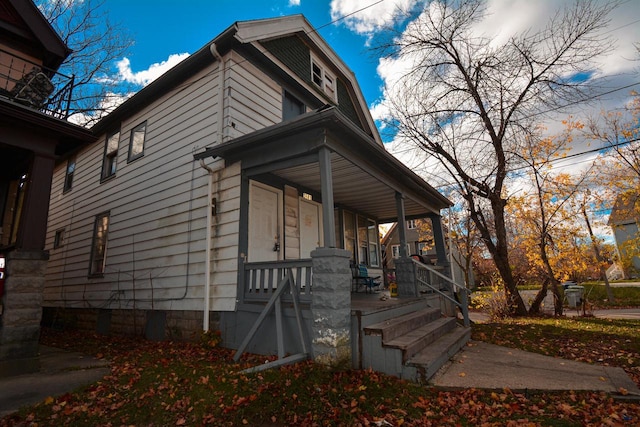 view of side of property featuring a porch