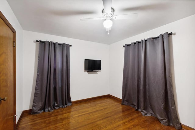 spare room featuring ceiling fan and dark hardwood / wood-style flooring