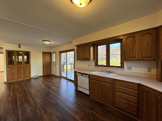 kitchen with dishwasher, sink, and dark hardwood / wood-style floors