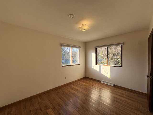 spare room with dark hardwood / wood-style flooring