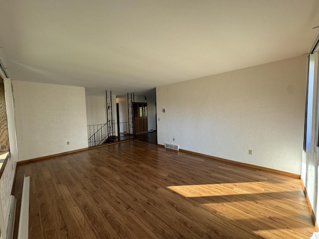 unfurnished room with hardwood / wood-style floors